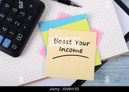 Adhesive note with text Boost your income home finance concept Stock Photo