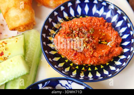 Dipping sauce with vegetables and snacks on a plate Stock Photo