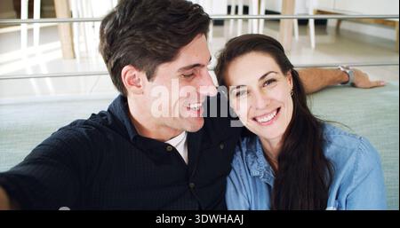 Smile, selfie and happy couple on couch, portrait and profile picture for memory, relax and funny. Home, man and woman in lounge, social media post Stock Photo