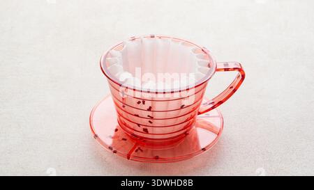 Red coffee dripper with paper filter Stock Photo
