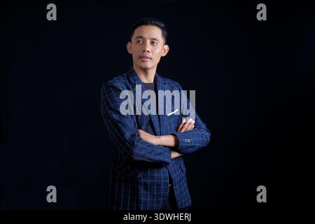 Business man in blue suit on dark background Stock Photo
