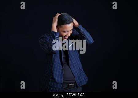 Business man in blue suit on dark background Stock Photo