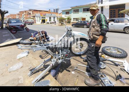 Sucre Bolivia October 8 a mechanic is assembling a motorcycle on the street, in the suburban area of Sucre. Shoot on October 8, 2019, Sucre, Bolivia Stock Photo