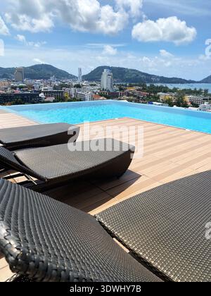 Wooden deck and lounge chairs by swimming pool Stock Photo - Alamy