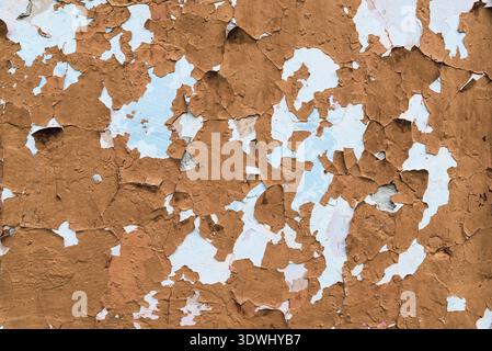 Old wall covered with cracked paint, aging caused by time Stock Photo