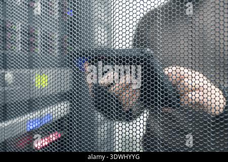IT technology unfocused background with copy space for text, IT specialist with tablet in the server room Stock Photo
