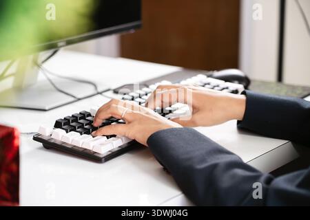 Focused businesswoman working on office computer during Christmas holidays. Stock Photo