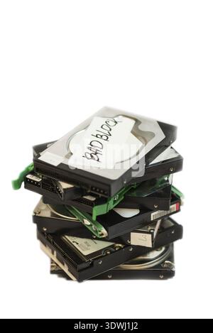 Stack of broken hard disk drives. Isolated on white background Stock Photo