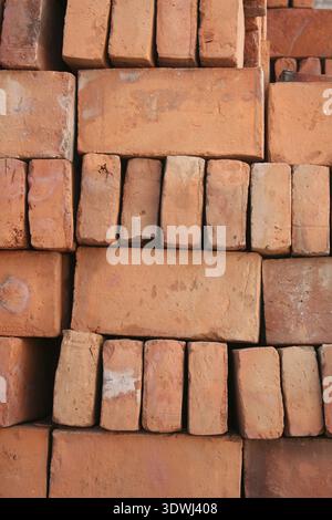 Handmade adobe bricks are stacked for sale at an outdoor brickyard in Cotacachi, Ecuador Stock Photo