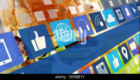 Displaying hamburger with melted cheese and lettuce under floating app icon tiles in studio Stock Photo