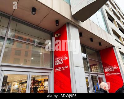 Manchester, UK - January 30, 2026: Bright red banners greet shoppers at a modern mall entrance in Manchester, UK, inviting exploration. Stock Photo