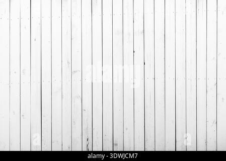 White wooden wall with a lot of cracks, knots and nails. Weathered timber planks, messy and dust, background with rich texture Stock Photo