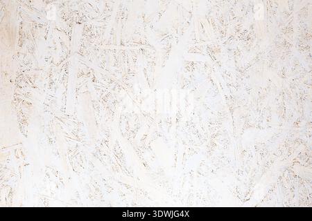 OSB panel texture. Oriented Strand Board. Chipboard building material. OSB wooden panel made of pressed sandy brown wood shavings as background closeu Stock Photo
