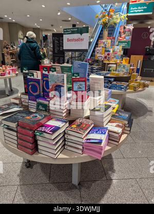 Pforzheim Germany Februar 25, 2026 Bestseller Table Stacked With Hardcover And Paperback, Customers Nearby Stock Photo