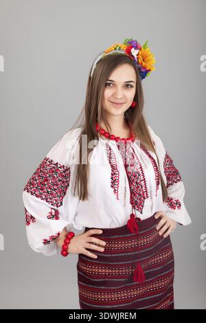 Attractive woman wears Ukrainian national dress isolated on a black background Stock Photo