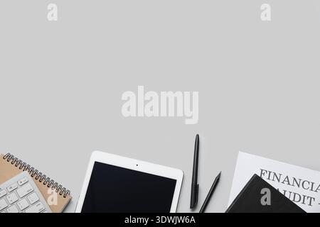 Composition with modern tablet computer and stationery on grey background Stock Photo