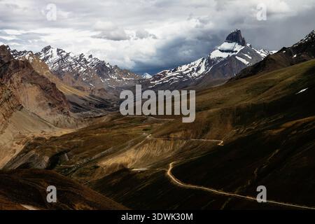 A breathtaking view of a rugged mountain landscape under dramatic skies. Stock Photo