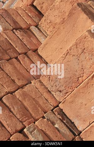 Handmade adobe bricks are stacked and ready for sale at an outdoor brickyard in Cotacachi, Ecuador Stock Photo