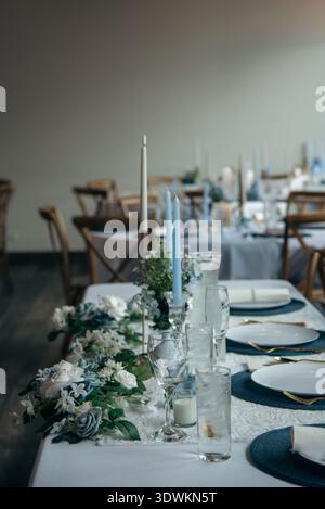 Wedding table with modern blue candles & glassware with copy space Stock Photo