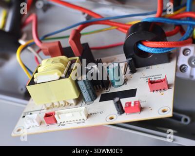 Image of a printed circuit board (PCB) containing various electronic components. Stock Photo