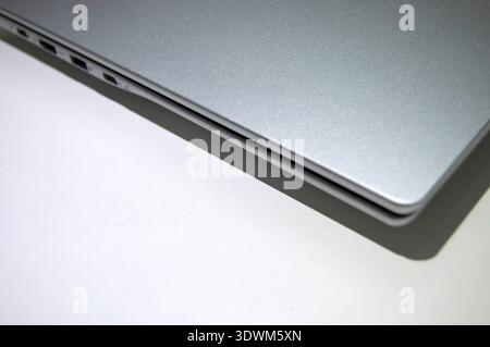 A laptop close-up with copy space. Technology frame with a silver laptop. Stock Photo