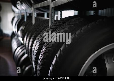 tire at repairing service garage background. Car tire in warehouse. Transportation and automotive maintenance concept Stock Photo