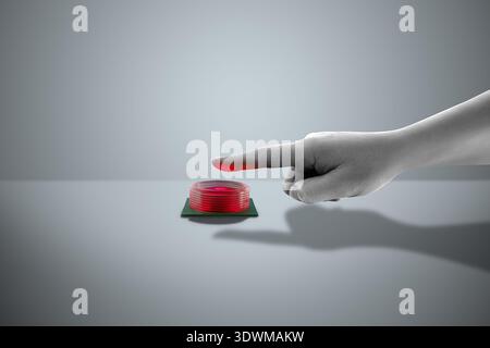 A hand pressing a red button on a gray surface. Flat design art with copy space. Stock Photo
