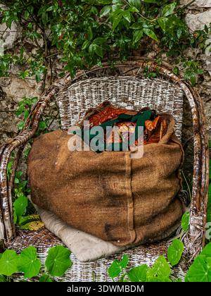 a sack full of dry leaves placed on a chair Stock Photo