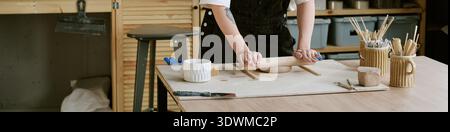 Header of Woman Shaping Clay with Rolling Pin in Pottery Studio Stock Photo