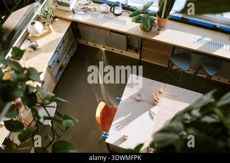 Empty Creative Workspace with Sunlight Illuminating Modern Art Supplies Stock Photo