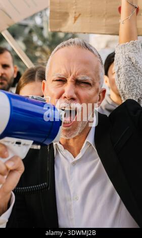 Mature man activist protesting for climate change with megaphone Stock Photo
