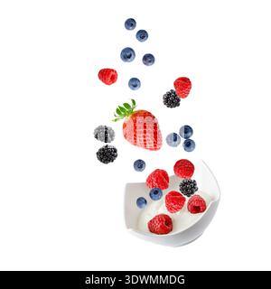 Fresh raspberry, blueberry, blackberry and strawberry berries falling into bowl with yogurt isolated on white background. Sweet raspberries, blueberri Stock Photo