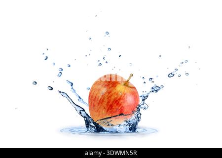 Fresh red yellow apple flying falling in splashing water isolated on white background. Stock Photo