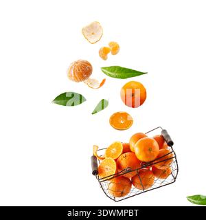 Fresh orange tangerines in brown metal basket, falling fruits and leaves isolated on white background Stock Photo