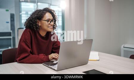 Woman Engaged In Collaborative UX Design Process Using Wireframes And Sticky Notes In Workspace Stock Photo
