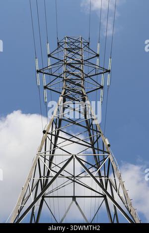 Electric transmission tower in front of cloudy sky Stock Photo