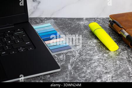 Image of laptop, notepad and highlight marker Stock Photo