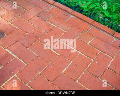 A fragment of a sidewalk made of red construction bricks Stock Photo