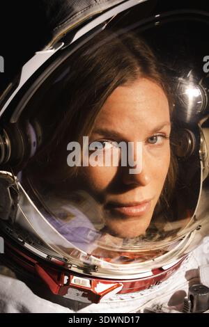 NASA astronaut Zena Cardman is captured in a close-up portrait from 2024, wearing her space suit helmet with the visor reflecting highlights. Her determined gaze looks directly forward, embodying a sense of exploration and the future of human spaceflight. This contemporary photograph highlights the dedication required for space travel. Stock Photo