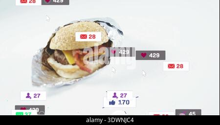 Sitting partially unwrapped cheeseburger on white tabletop with crumpled foil, notification badges Stock Photo