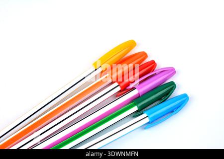 Close up view of multicolor ball point pen .Ballpoint pens. Choice of handles. Colored pens. Ink pens for writing. Pens lie on the notepad page. Offic Stock Photo
