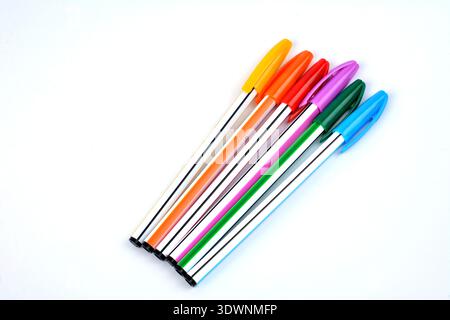 Close up view of multicolor ball point pen .Ballpoint pens. Choice of handles. Colored pens. Ink pens for writing. Pens lie on the notepad page. Offic Stock Photo