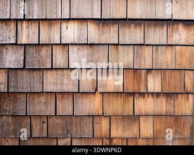 Natural weathered wooden shingles texture background, traditional rustic cedar shakes wall cladding pattern Stock Photo