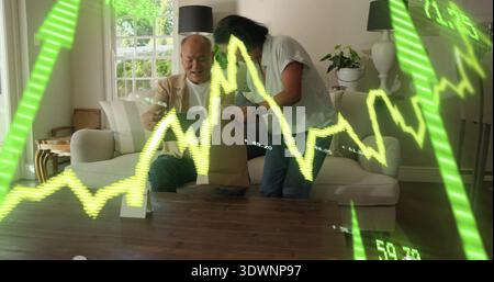 Sharing Chinese man in blazer and senior woman reaching into brown bag on sofa, neon-stock overlay Stock Photo
