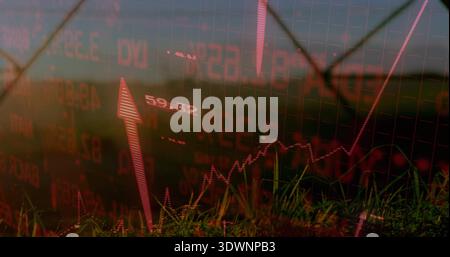 Displaying financial chart overlay with upward arrow, grid over farmland with fence and towers Stock Photo