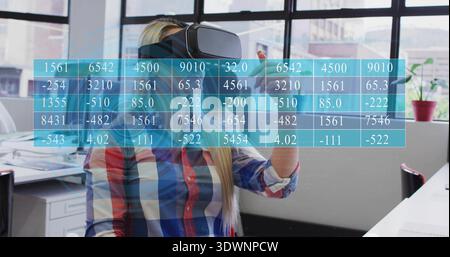 Interacting woman wearing VR headset and plaid shirt manipulating holographic grid at workstation Stock Photo