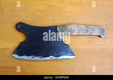 Vintage Meat cleaver on dark wooden background.Old kitchen knife for meat Stock Photo