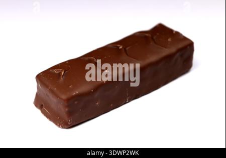 Close-up of sweet milk chocolate candy snickers bars on blurred canvas copy space background. Tasty nutritious food concept. Stock Photo