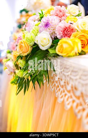 Festive flower composition on the yellow background. Overhead view Stock Photo