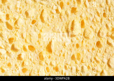 Closeup Shot Highlighting Soft Foam And Deep Pores On Yellow Cleaning Sponge Stock Photo